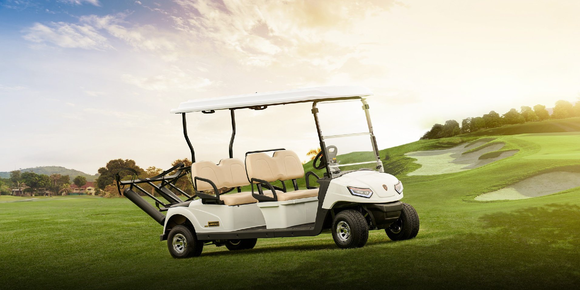 Four-seat golf cart with a white canopy, standing on a fairway