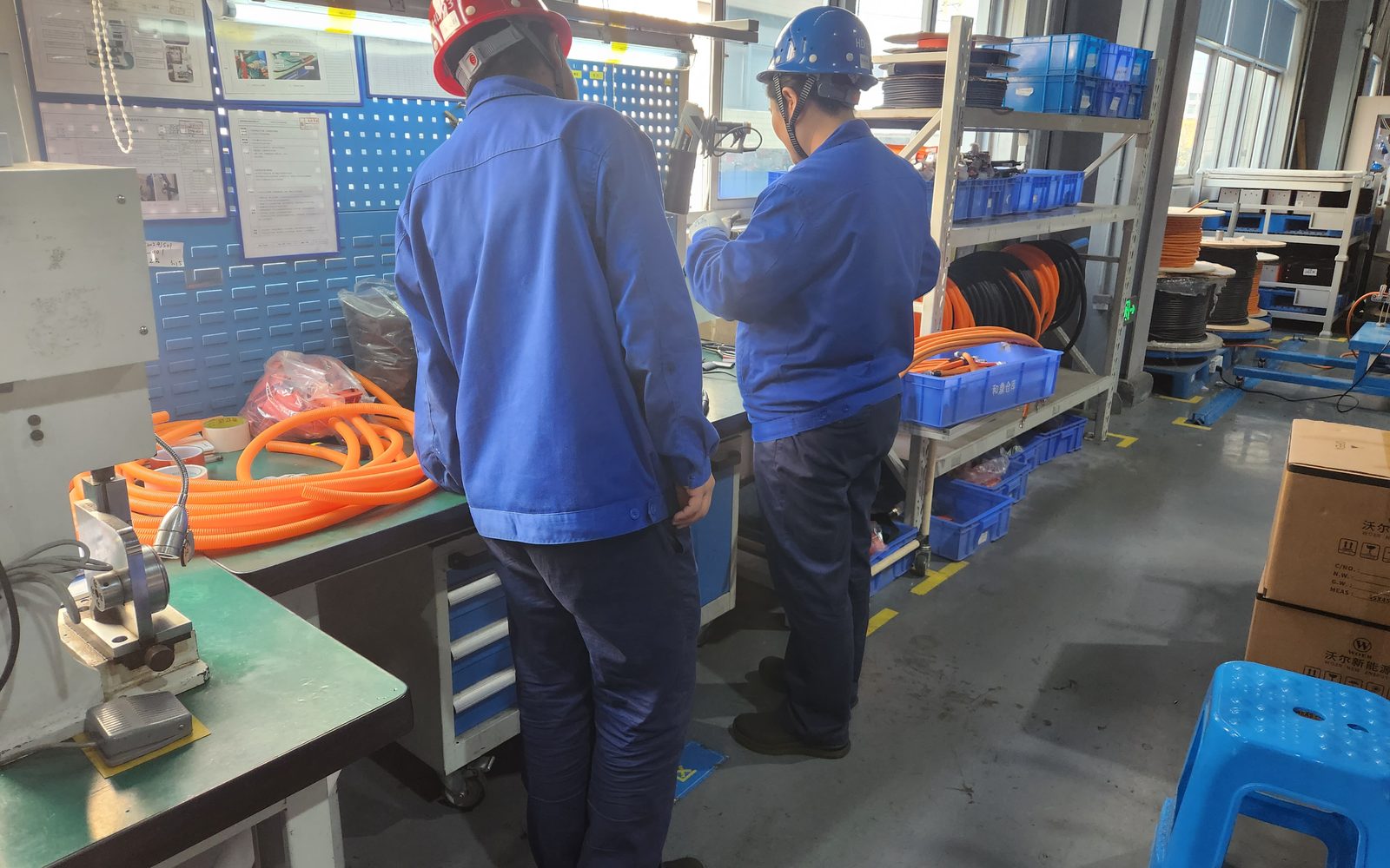Technicians wiring a PACK at the bench