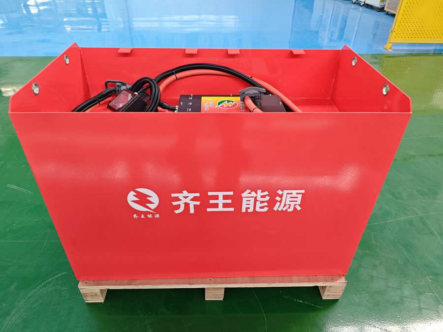 Red LiFePO4 traction pack with rating label and wordmark, palletised for dispatch