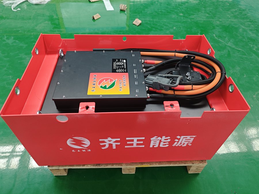 Red LiFePO4 traction pack staged on the dispatch floor